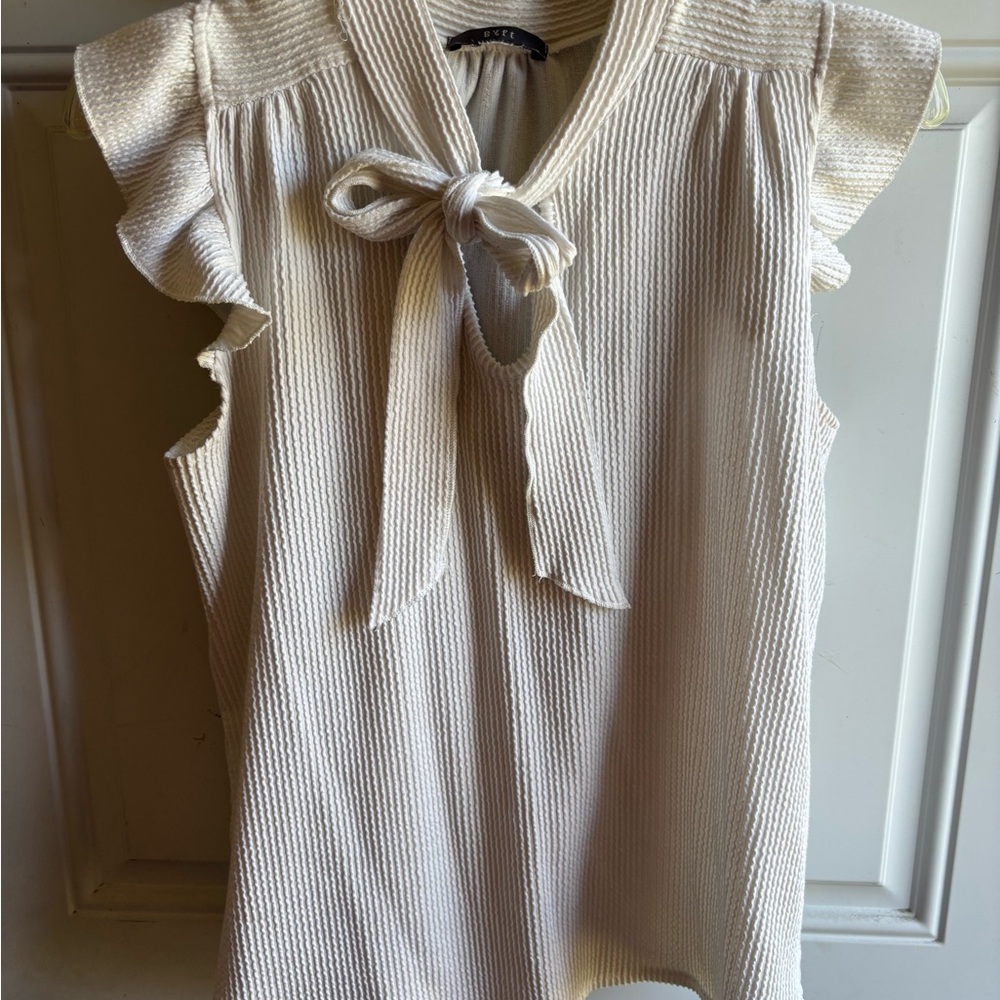 Sleeveless Tie-Neck Ruffle Blouse in Cream